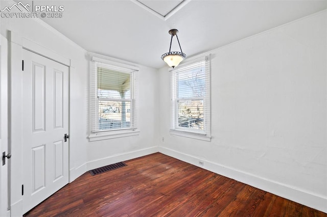 interior space featuring baseboards, visible vents, and dark wood finished floors