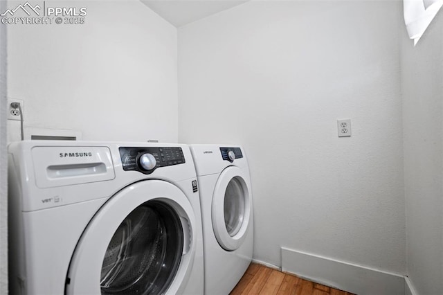 washroom featuring laundry area, light wood finished floors, and independent washer and dryer