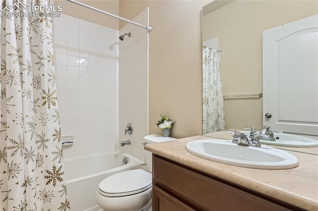 full bath with shower / tub combo, a textured wall, vanity, and toilet