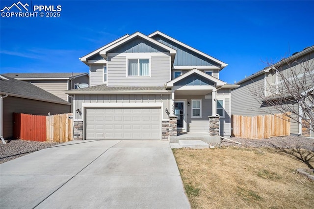 craftsman-style house with concrete driveway, board and batten siding, and fence