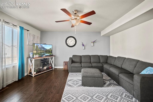 living area featuring ceiling fan, a textured ceiling, baseboards, and wood finished floors