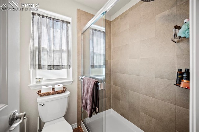 full bathroom with a shower stall and toilet