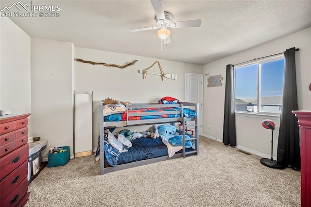 carpeted bedroom featuring a ceiling fan, a textured ceiling, and baseboards