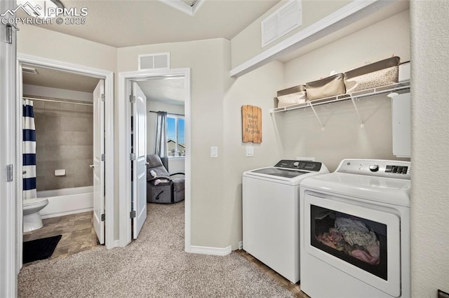 clothes washing area with laundry area, independent washer and dryer, visible vents, and light colored carpet