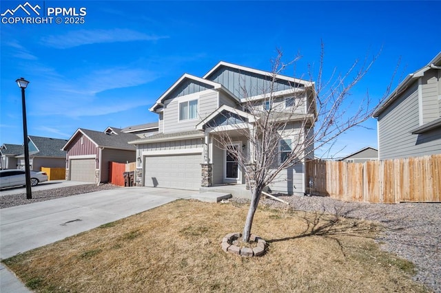 craftsman-style home featuring driveway, stone siding, an attached garage, fence, and board and batten siding