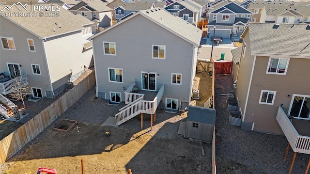 back of house with a fenced backyard and a residential view