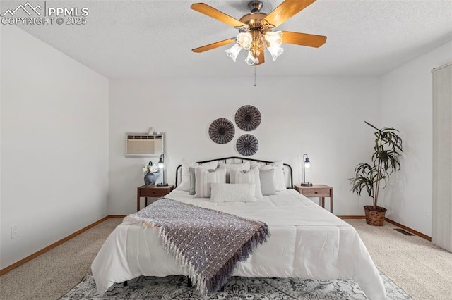 bedroom with carpet floors, ceiling fan, baseboards, and a textured ceiling