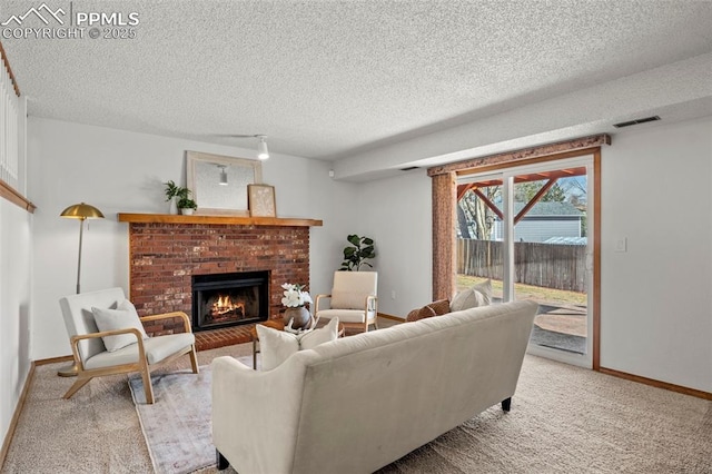 living room featuring a fireplace, visible vents, light carpet, a textured ceiling, and baseboards