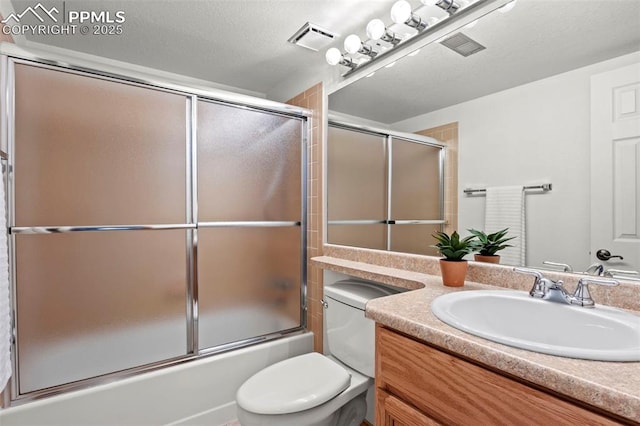 bathroom featuring a textured ceiling, toilet, shower / bath combination with glass door, vanity, and visible vents