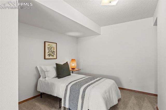 bedroom with carpet flooring, a textured ceiling, and baseboards