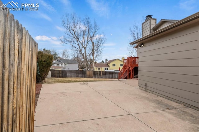 view of patio / terrace featuring stairway and a fenced backyard