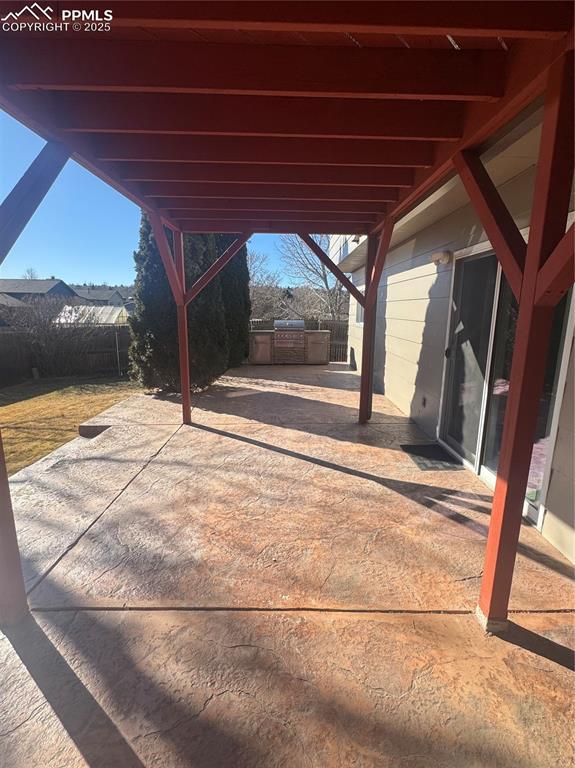 view of patio / terrace featuring a carport and a fenced backyard