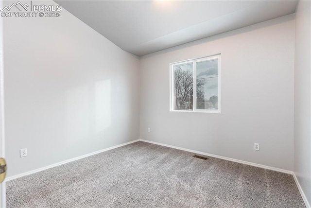 carpeted spare room with visible vents and baseboards