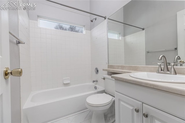 full bath with toilet, marble finish floor, a wealth of natural light, and vanity