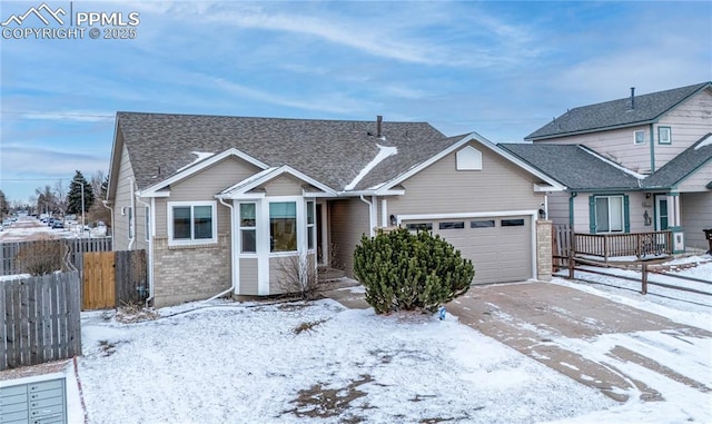 view of front of property with brick siding, roof with shingles, an attached garage, fence, and driveway