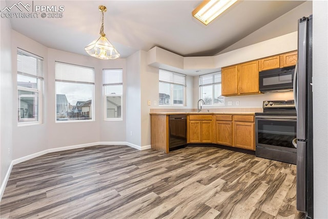 kitchen with lofted ceiling, light countertops, dark wood-type flooring, a sink, and black appliances