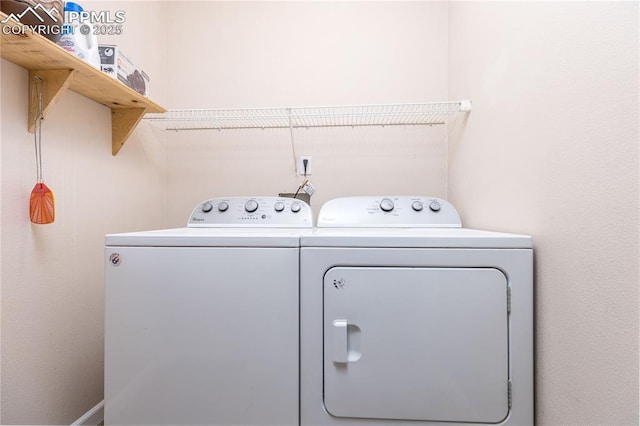 clothes washing area with laundry area and washing machine and clothes dryer