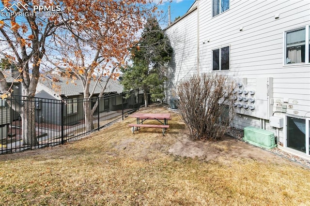 view of yard featuring fence and central AC unit