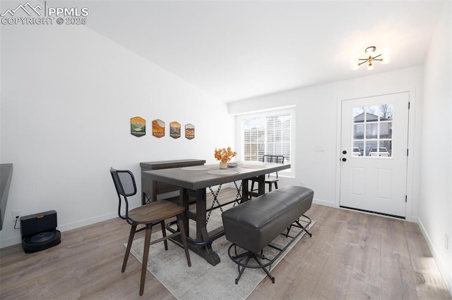 dining area with light wood-style floors and baseboards