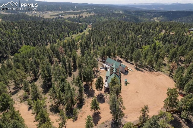 birds eye view of property featuring a wooded view