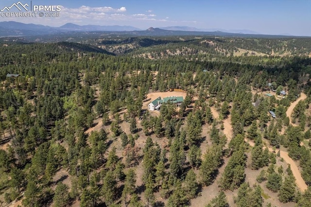 bird's eye view with a mountain view and a forest view