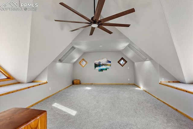 additional living space with lofted ceiling, baseboards, and carpet flooring