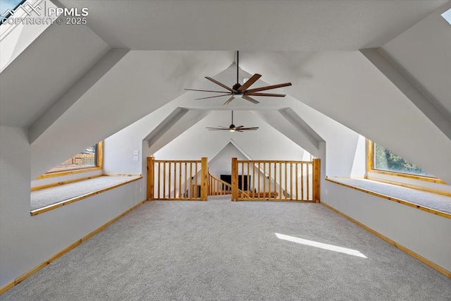 bonus room with lofted ceiling, carpet floors, and baseboards