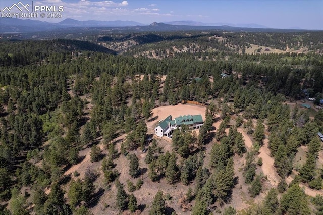 bird's eye view featuring a wooded view and a mountain view