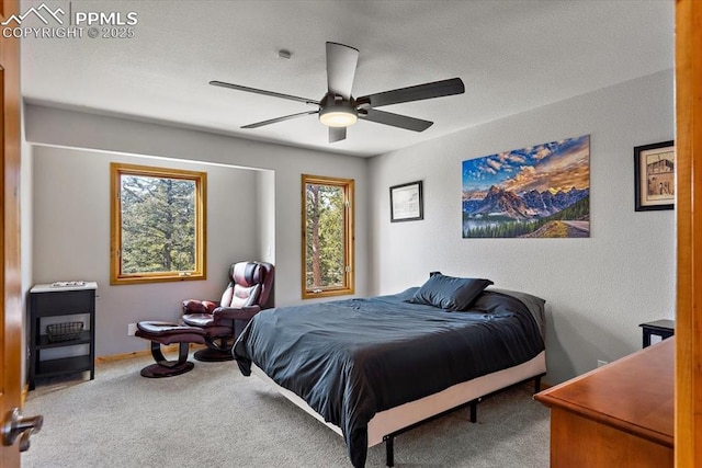 bedroom with carpet floors, a textured ceiling, and a ceiling fan