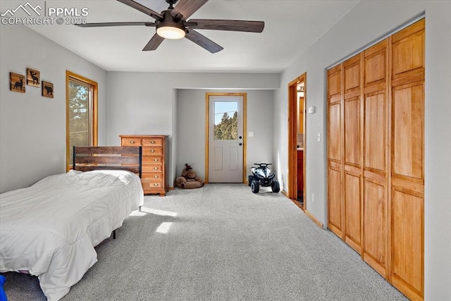 bedroom featuring a closet, light colored carpet, and ceiling fan