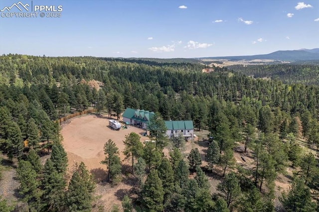 drone / aerial view with a forest view and a mountain view