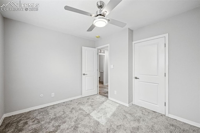 unfurnished bedroom featuring carpet, baseboards, and a ceiling fan