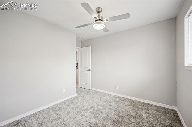 empty room with carpet, baseboards, and a ceiling fan