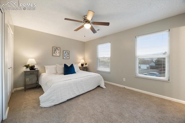 bedroom featuring carpet, baseboards, and a textured ceiling