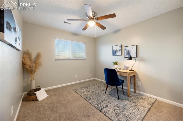 carpeted office space featuring visible vents, ceiling fan, a textured ceiling, and baseboards