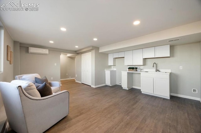 interior space with visible vents, baseboards, dark wood-type flooring, a wall mounted AC, and recessed lighting