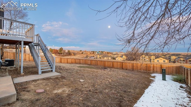 view of yard with a fenced backyard, a residential view, and stairway