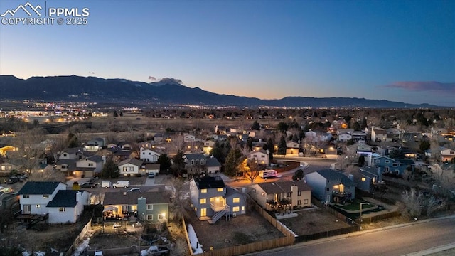 drone / aerial view featuring a residential view and a mountain view