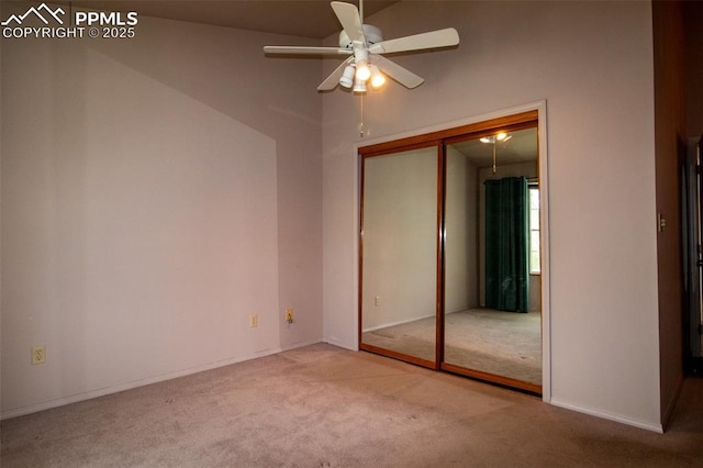 unfurnished bedroom featuring a closet, a ceiling fan, and carpet flooring