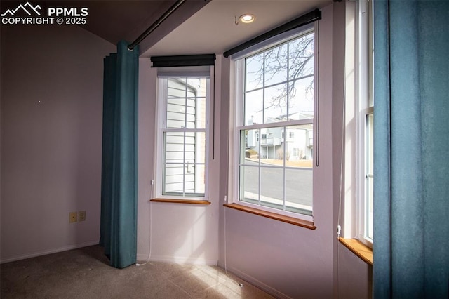 doorway to outside featuring carpet flooring and baseboards