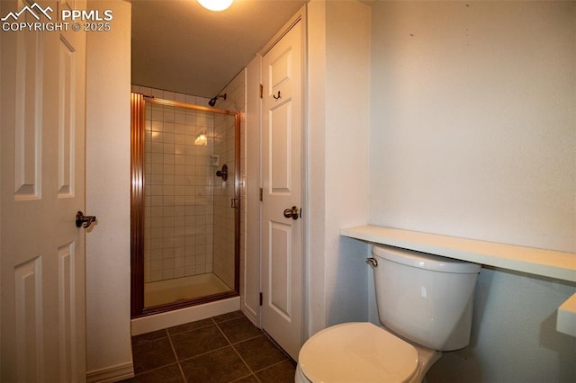 bathroom featuring toilet, a shower stall, and tile patterned floors