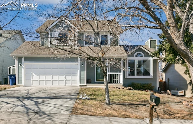 traditional-style house featuring a garage, driveway, a chimney, and roof with shingles