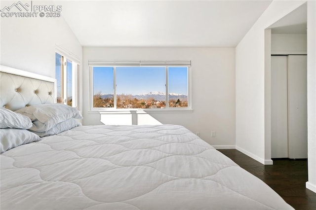 bedroom with baseboards and wood finished floors