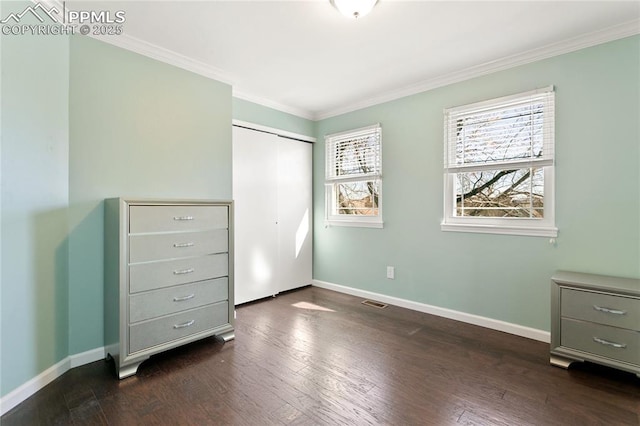 unfurnished bedroom featuring ornamental molding, dark wood-style flooring, and baseboards