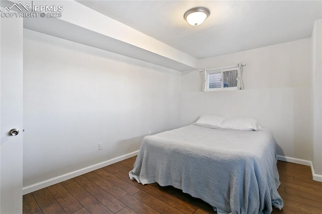 bedroom with hardwood / wood-style flooring and baseboards