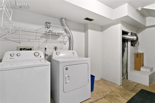 washroom featuring laundry area and washing machine and clothes dryer