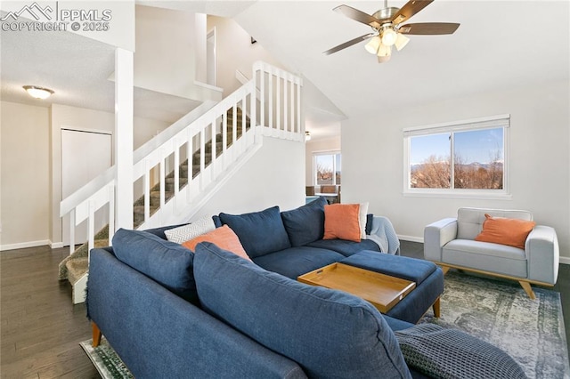 living area with stairway, ceiling fan, wood finished floors, high vaulted ceiling, and baseboards