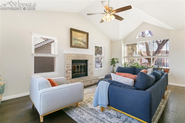 living area with lofted ceiling, a brick fireplace, baseboards, and wood finished floors