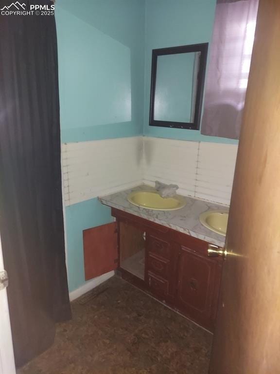 bathroom featuring a sink and double vanity