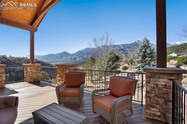 wooden deck featuring a mountain view